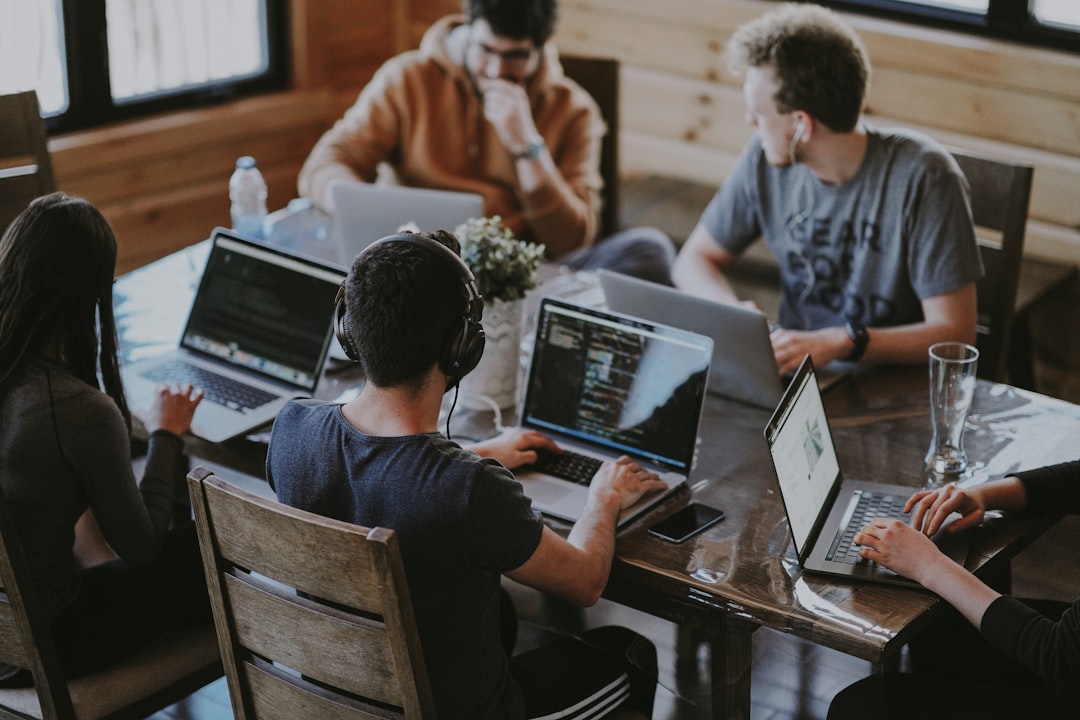 Business team reviewing a software project plan in a modern office (Photo by Annie Spratt on Unsplash)
